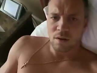 Russian footballer Artem Dzyuba playing on hotel bed